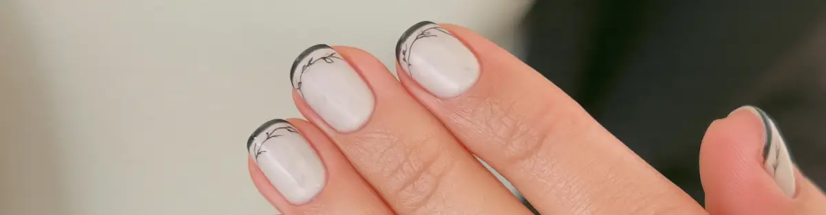 Minimalist black and cloud dancer nail art design