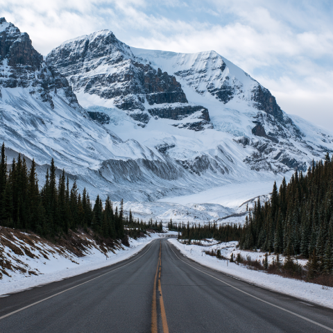 Snow-covered jagged mountain summits along the Icefields Parkway
