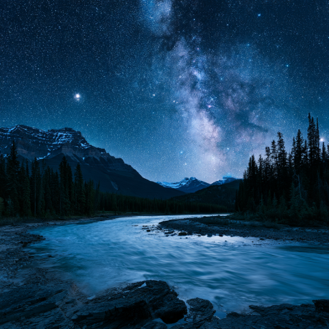 Clear starry night sky over mountain lake in Jasper Dark Sky Preserve