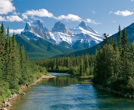 Canmore mountain peaks reflecting in clear calm waters