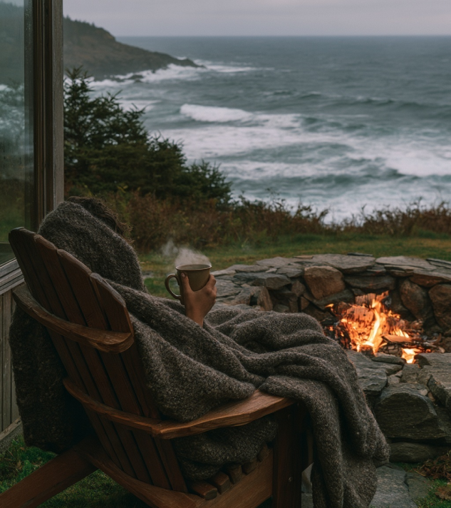 Relaxation deck with wool blankets looking over coastal waters