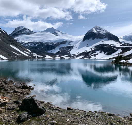 Alpine mountain lake reflecting jagged peaks in British Columbia
