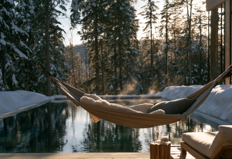 Relaxation room with thermal hammocks and fireplace in a Quebec spa