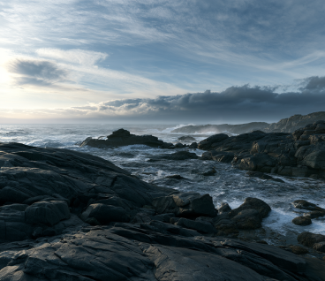 Rugged North Atlantic coastline, granite rocks and maritime sky
